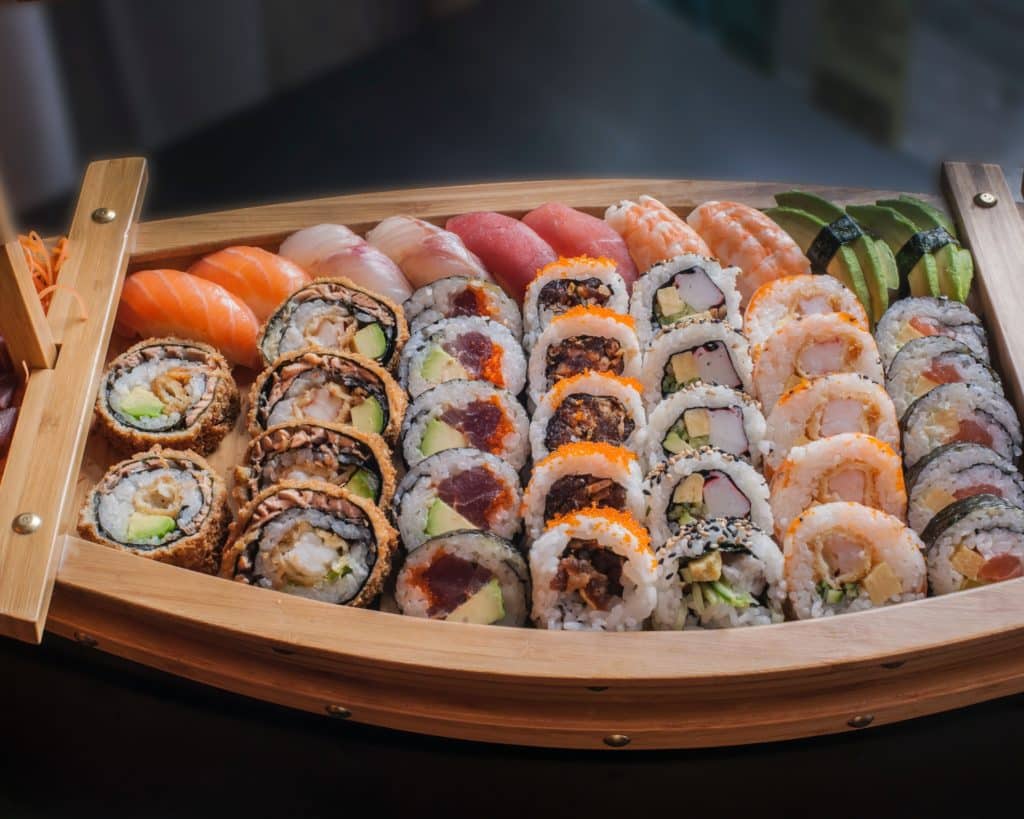 A wooden bowl filled with sushi at a Japanese restaurant.