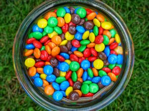 A bowl filled with multi-colored M&Ms. 
