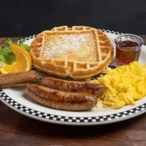 A waffle with sausage and eggs at Black Bear Diner.