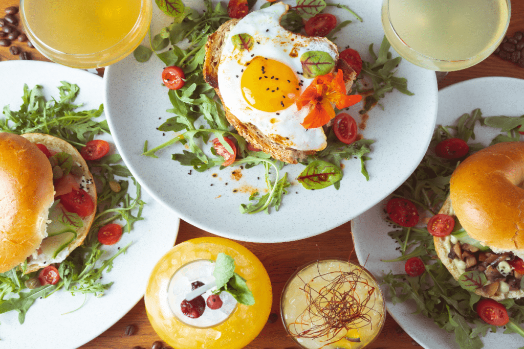 Brunch items at a bottomless brunch including fried eggs on toast and mimosas