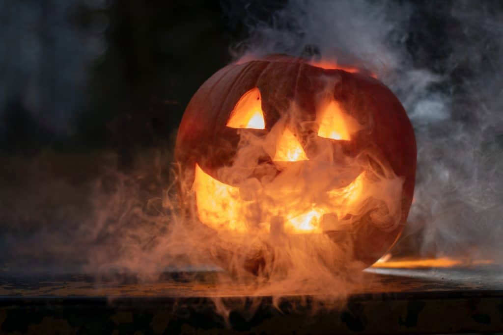 A jack-o-lantern covered in smoke at Halloween