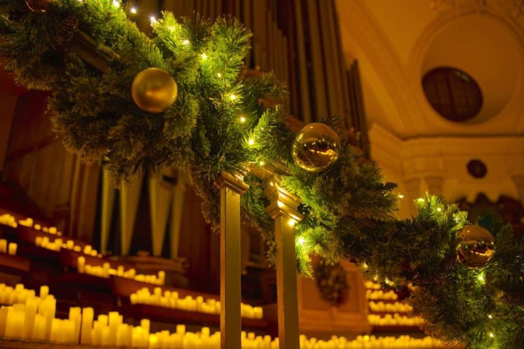 Stairs decorated with baubles and candles for a Christmas Candlelight concert.