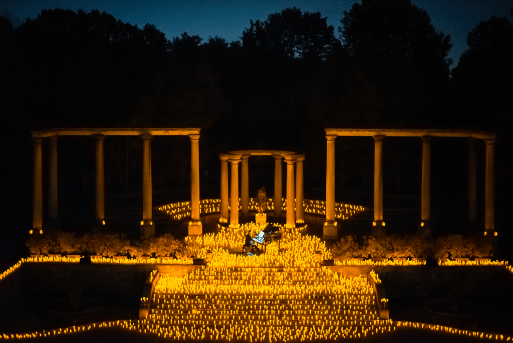 A wide shot of an open-air Candlelight concert 