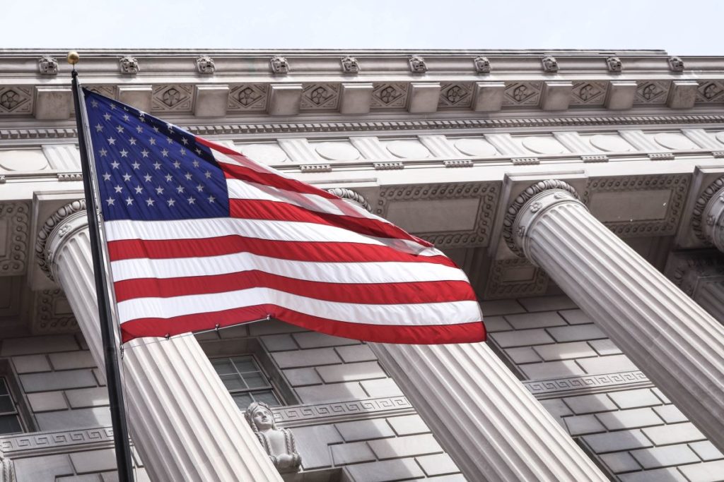 The American flag in front of U.S. Department of Commerce, Washington, United States