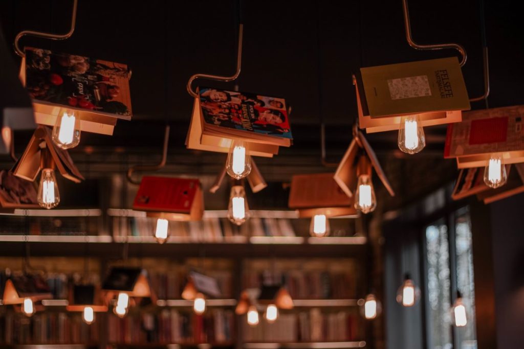Books hanging from ceiling lights.