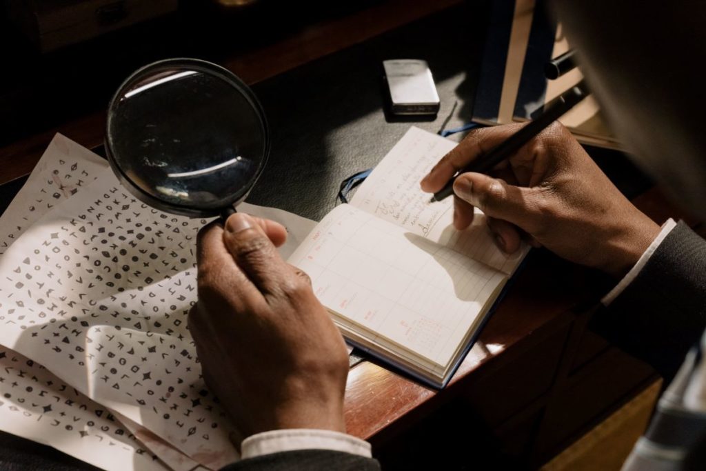 A detective writing in a notebook.
