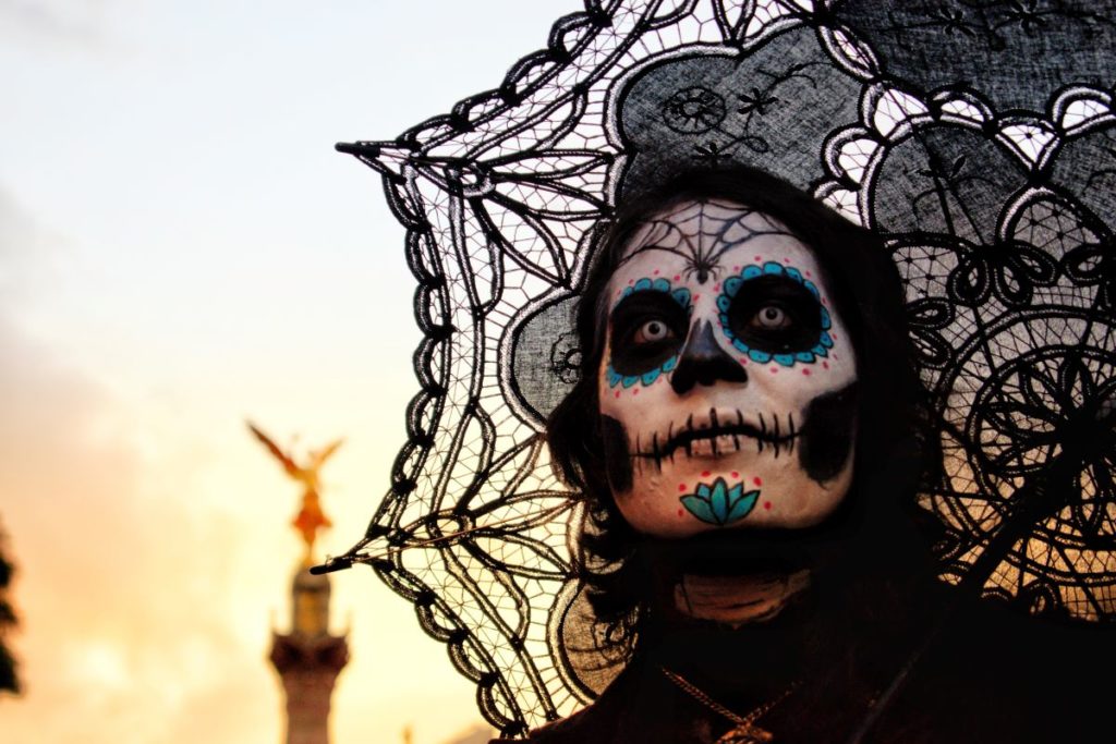A person in costume for Día de los Muertos.